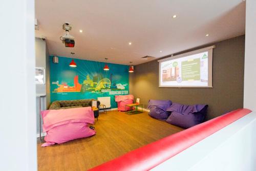 a living room filled with furniture and a tv at YHA Manchester in Manchester