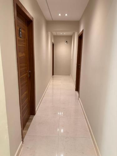 a corridor in a building with white walls and a tile floor at Giza Palace Pyramids View in Cairo