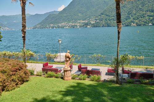a statue in a park next to a body of water at Hotel Villa Flori in Como