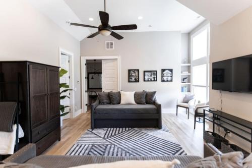 a living room with a couch and a ceiling fan at Minutes to Downtown Huge Outdoor Deck HOT TUB in Nashville