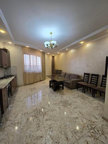 a living room with a couch and a table at Noragavit Villa in Yerevan