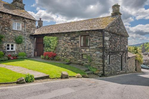 an old stone house with a grass yard at Dwarf Hall - central Ambleside in Ambleside