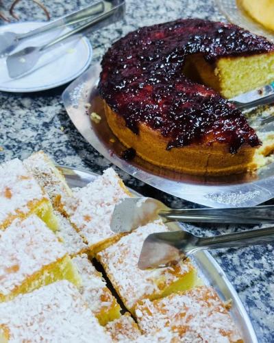 a table with a cake and a plate of desserts at Skalla Hotel Nova Odessa in Nova Odessa