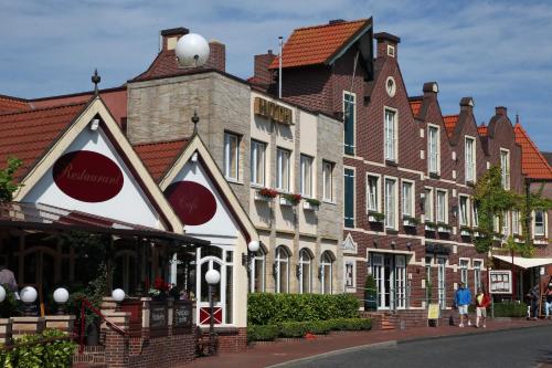 a row of buildings on a street in a town at Hotel Altes Zollhaus in Horumersiel