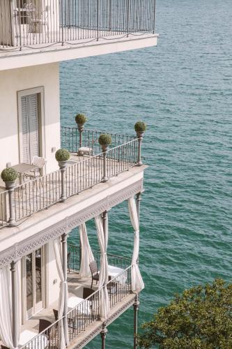 a balcony of a building with a view of the water at Hotel Villa Flori in Como