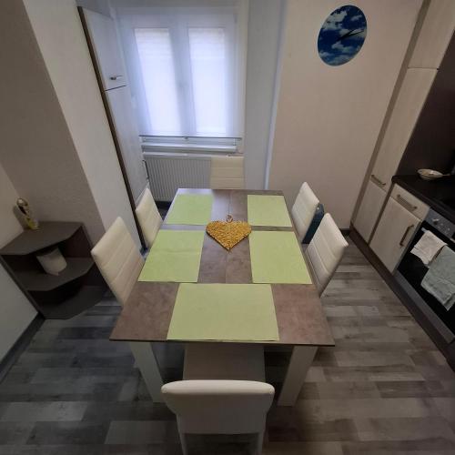 a dining room table with a heart on it at GRooms in Gemmrigheim