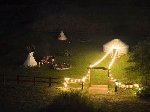 a group of people camping in a field at night at Agricampeggio Equinox in Carpignano Sesia