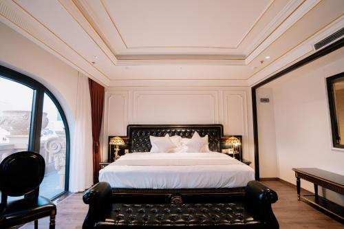 a bedroom with a large bed and a window at Bao An Hotel Hung Yen in HÆ°ng YÃªn