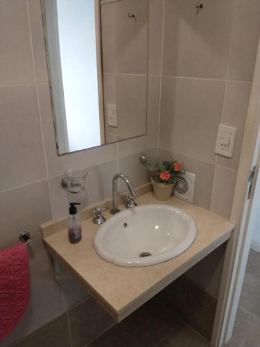 a bathroom with a sink with a mirror and a counter at Apart -Hotel Rio Manso "Habitación 22" in Victoria