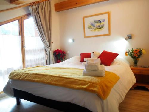 une chambre avec un lit avec un ours en peluche dessus dans l'établissement Chalet Les Barmés, à Champagny-en-Vanoise