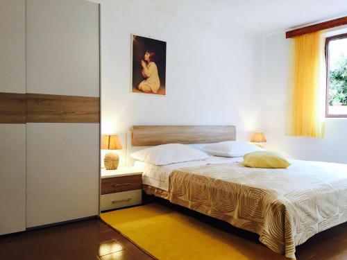 a bedroom with a large bed and a window at House BORA with sea view 70m from the beach in Blato