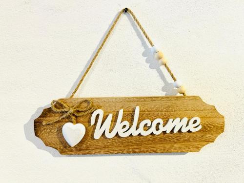 a wooden sign with the word welcome at Appartement duplex spacieux in Fleurier