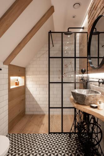 a bathroom with a sink and a staircase at Villa La Roca Garden and Spa in Kościelisko