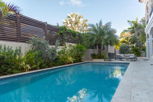 a swimming pool in the backyard of a house at Opal Rental II in Palm-Eagle Beach