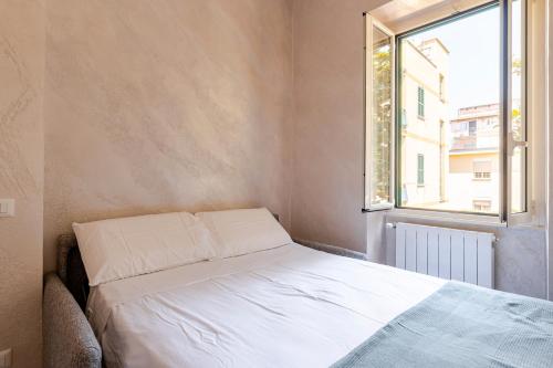 a bed in a small room with a window at Amars House in Rome