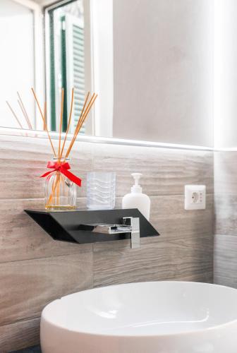 a bathroom with a white sink and a mirror at Amars House in Rome
