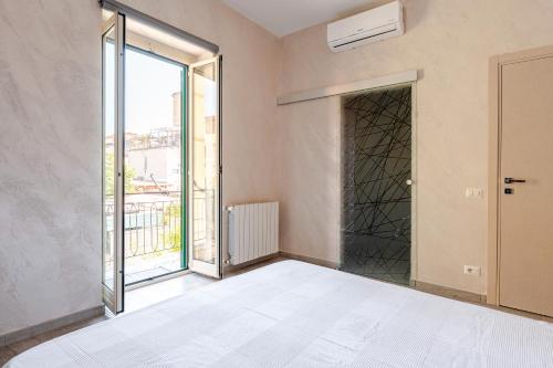 an empty room with a bed and a window at Amars House in Rome