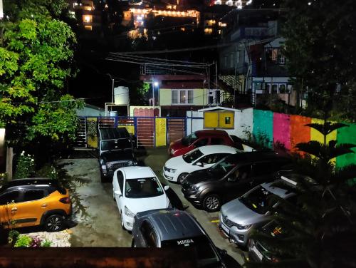 a group of cars parked in a parking lot at night at Misba Homestay Kodai in Kodaikānāl