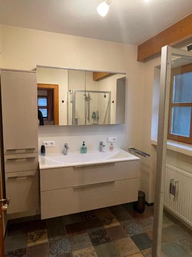 a bathroom with a sink and a mirror at Landhaus Franziskus in Reit im Winkl