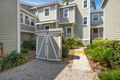a shed in front of a row of houses at Whitman by the C townhouse in Cedar Key