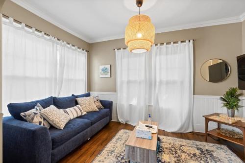 a living room with a blue couch and a table at Uptown Cottage- mins away from Downtown in Chattanooga