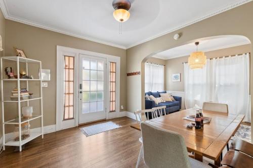 a dining room and living room with a table and chairs at Uptown Cottage- mins away from Downtown in Chattanooga