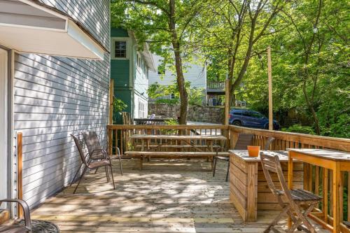 a patio with chairs and a table and benches at Uptown Cottage- mins away from Downtown in Chattanooga