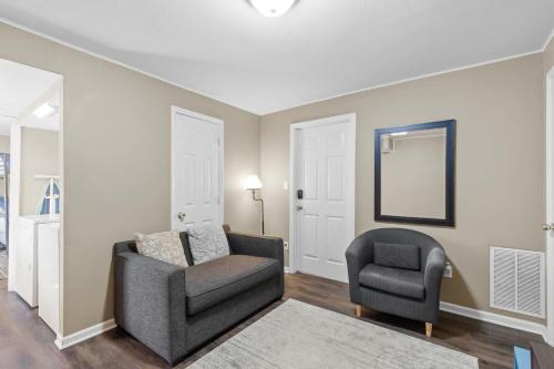 a living room with a chair and a chair at Uptown Cottage- mins away from Downtown in Chattanooga