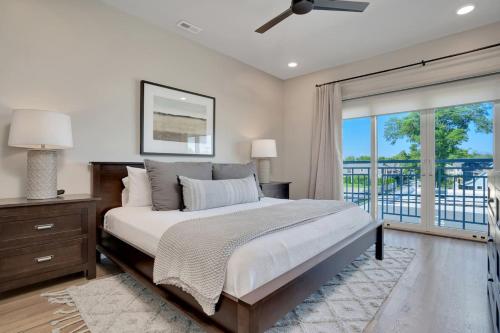a bedroom with a large bed and a balcony at Main Street Retreat Chatt in Chattanooga