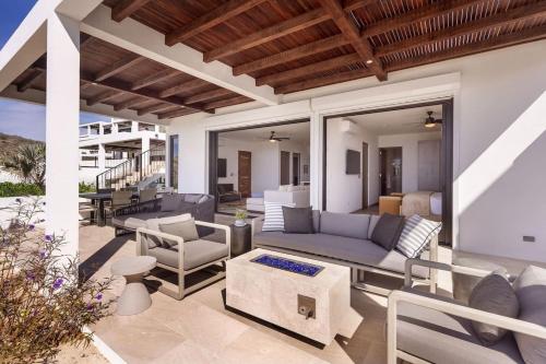 an outdoor patio with a couch and chairs at Boutique Ocean Escape with Relaxing Amenities in El Pescadero