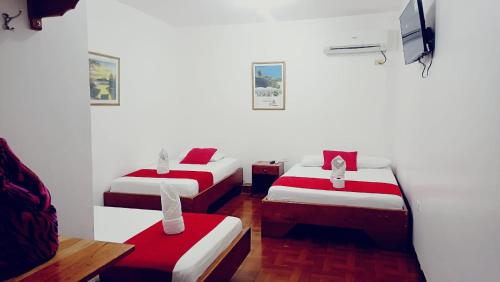 Postel nebo postele na pokoji v ubytování Hostal El Pinzón