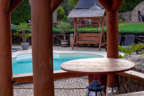 a small pool with a table and a gazebo at Zámeček Kaliště in Poddubí