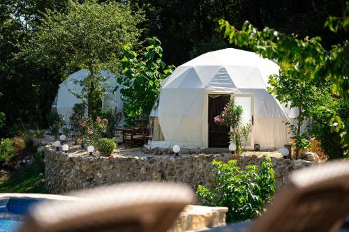 a white dome tent in a garden with plants at ZEN Relaxing Village in Cetinje
