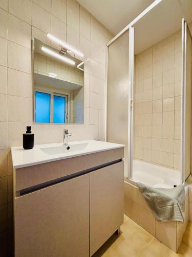 a bathroom with a sink and a mirror and a tub at Casa da Laurinha in Arcos de Valdevez