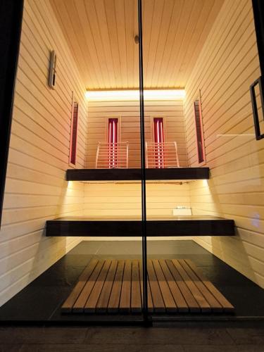 a sauna with two red chairs in the background at Apartament WROTA DO PUSZCZY Z SAUNĄ in Hajnówka