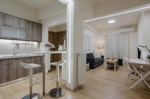 a kitchen and living room with a couch and a table at 44m2 feels like home in Karditsa