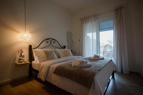 a bedroom with a bed with towels on it at 44m2 feels like home in Karditsa