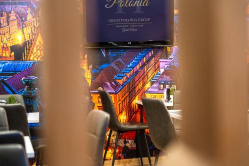 a view of a stage with chairs and a tv at Great Polonia Dwarf Wrocław in Wrocław
