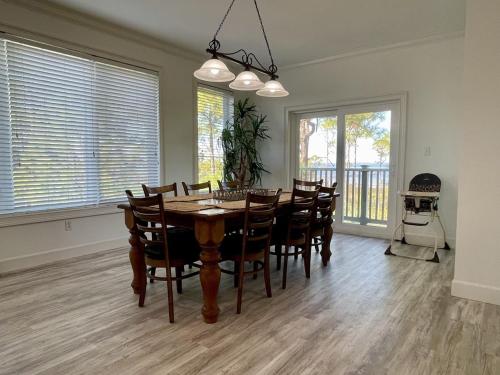 a dining room with a table and chairs at Pleasant Tides in St. George Island