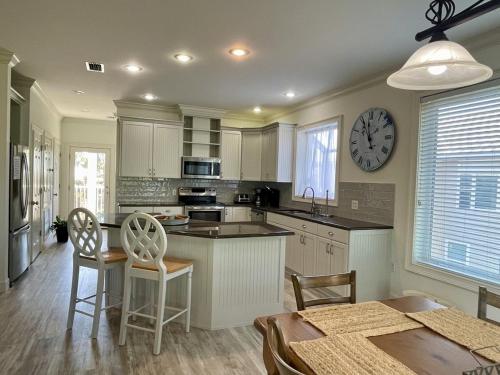 a kitchen with a table and a clock on the wall at Pleasant Tides in St. George Island