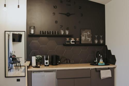 a kitchen with a counter and a clock on the wall at Light house in Cēsis