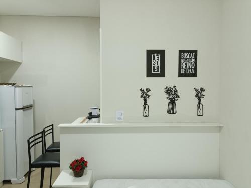a kitchen with a counter with vases with flowers at Cantinho da Paz in Sao Paulo