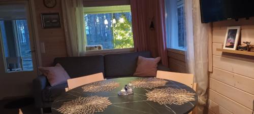 a living room with a table and a couch at Villa in Kalajoki