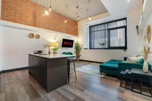 an open living room with a couch and a table at Stay Angels - Blonk Street Sheffield Luxury Apartments in Sheffield