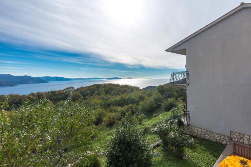 a building with a view of a body of water at Apartman Fonovici in Juraši
