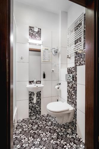 a bathroom with a toilet and a sink at Great Polonia Dwarf Wrocław in Wrocław
