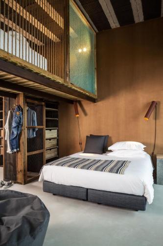 a bedroom with a large bed in a room at Noah Surf House Portugal in Santa Cruz