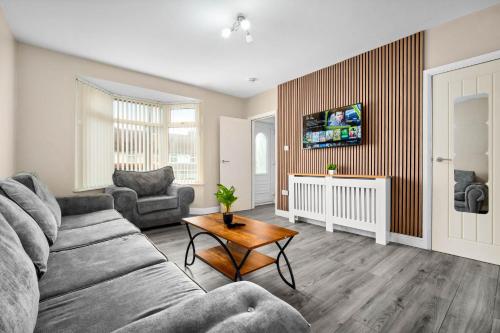 a living room with a couch and a table at House In Erdington in Birmingham