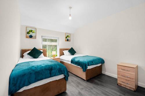 a bedroom with two beds and a window at House In Erdington in Birmingham