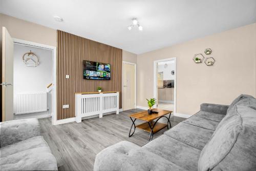 a living room with a couch and a table at House In Erdington in Birmingham